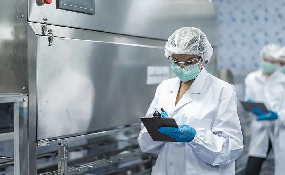 Woman with clipboard in factory